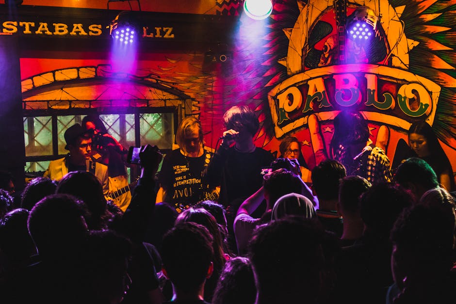 Live band performing in a lively and colorful club atmosphere with a cheering crowd enjoying the music